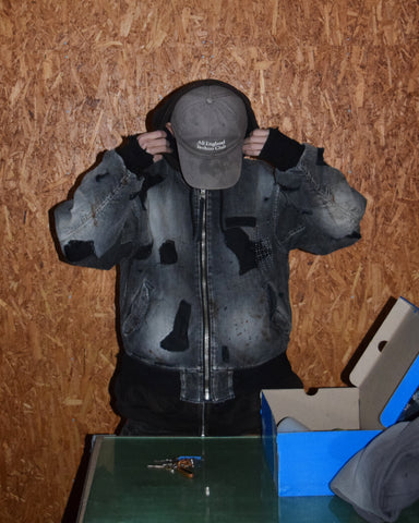 ブランドを象徴するデニムで構築した、MA-1ベースのリメイクジャケット。ライトオンスデニムを二重縫製することで、柔らかさと程よい肉感を実現しています。8ozムラ糸デニムがもつ粗野な表情が、強いヴィンテージ感を演出。全体にエイジングを施したうえで、ハードダメージ加工で仕上げた一着。さらに手作業による多様なステッチ補修を重ね、唯一無二の表情に仕上げています。Crafted from the brand’s signature denim, this MA-1–inspired jacket features a refined and faithful silhouette.Lightweight denim with double stitching creates a soft feel and balanced structure.The 8oz slub denim offers a rugged character that enhances its vintage appeal.An overall aging treatment is followed by a hard damage finis
