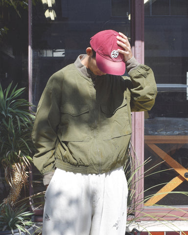 1950年代の希少なフライトジャケットをベースにシルエットを調整し、特徴的なディテールを再現したオリーブカラーのジャケット。
生地にはM1951 ARCTIC OVER PANTSを解析して再現したリプロ素材を使用し、光沢感のあるブライトナイロンを採用。
毛焼きをせずタンブラー仕上げでヴィンテージ感を演出しています。