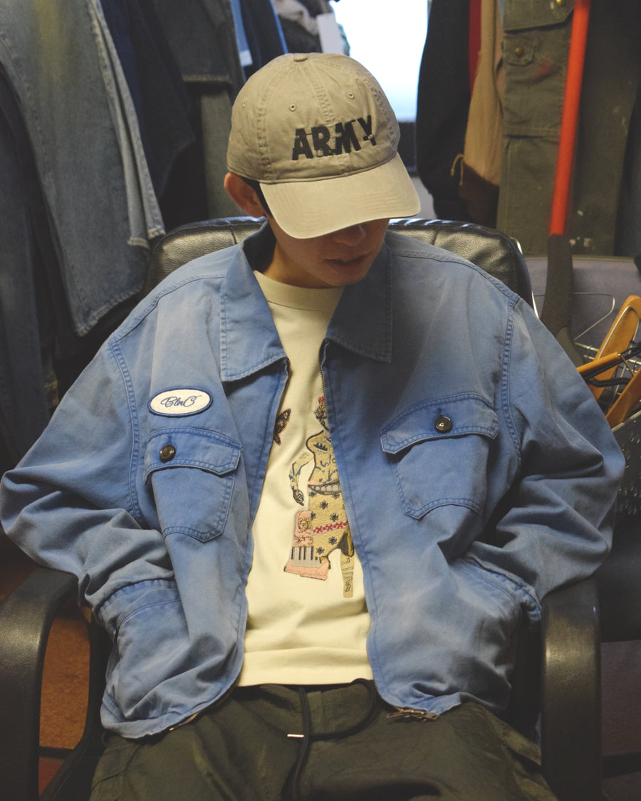 ヴィンテージのワークジャケットを現代的シルエットで再現。柔らかくコシのある20番手ツイルに、環境負荷を抑えた特殊エイジング・サンフェード加工を施し、長年着込んだようなリアルな色落ちを表現しました。
裏地には高密度なコットンスレーキを採用。鮮やかなブルーのボディに、オリジナルワッペンがアクセントを添える、風合い豊かな一着です。
A modern reimagining of the classic vintage work jacket. Made from soft 20s twill and treated with a special sun-fade process for a realistic aged look, this BLUE jacket features high-density lining and original custom patches for a unique, heritage-inspired finish.