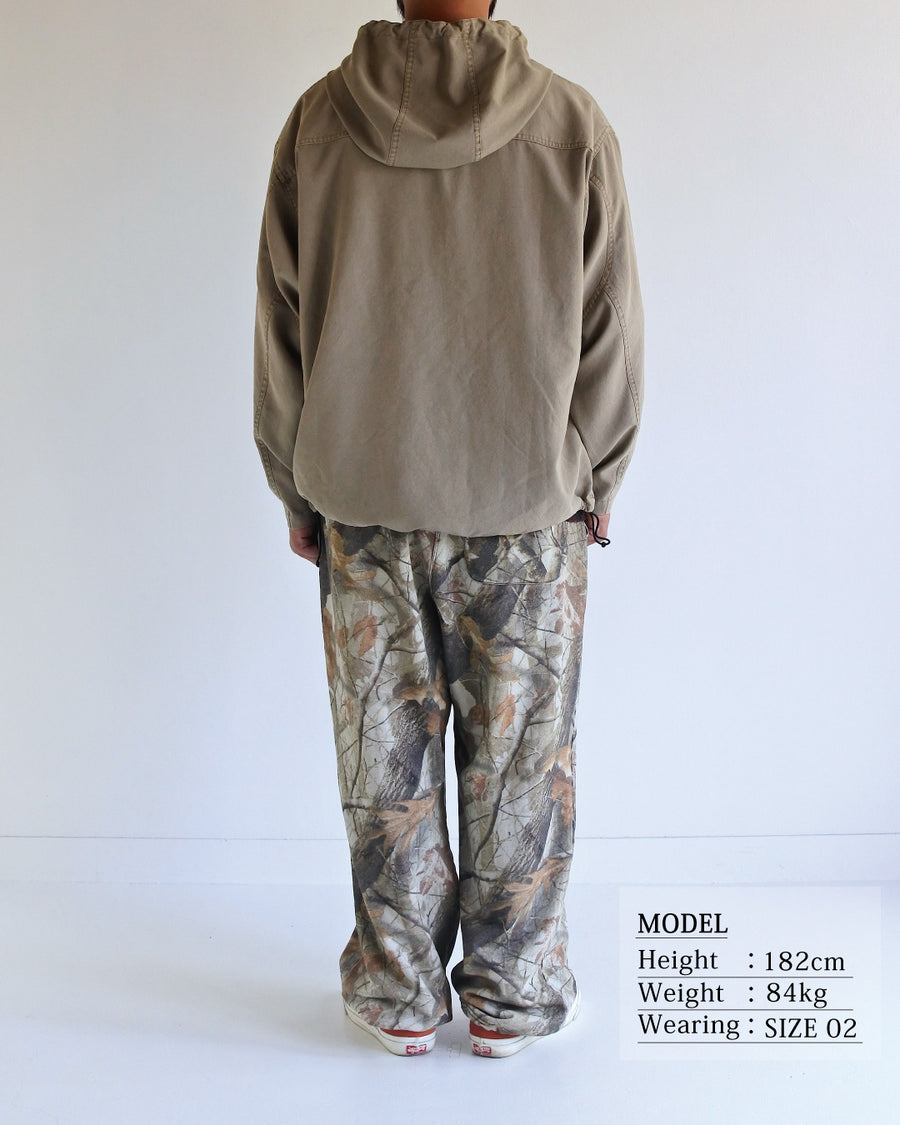 ポリエステル100％でありながら、綿のような質感と軽量性を備えた高機能な一着。タスラン加工糸を使用したポリエステルオックスを採用し、シワになりにくく速乾性に優れたイージーケア性を実現しました。本来染色が困難な素材に特殊顔料染めを施すことで、化繊特有の光沢を抑えた、ナチュラルで奥行きのある絶妙なフェード感を表現しています。

A high-performance piece crafted from polyester oxford, offering a cotton-like touch with lightweight, quick-dry, and wrinkle-resistant properties. This GRAY BEIGE item features a special pigment dye—a rare process for polyester—achieving a sophisticated, faded texture and a matte finish that defies its synthetic origins.