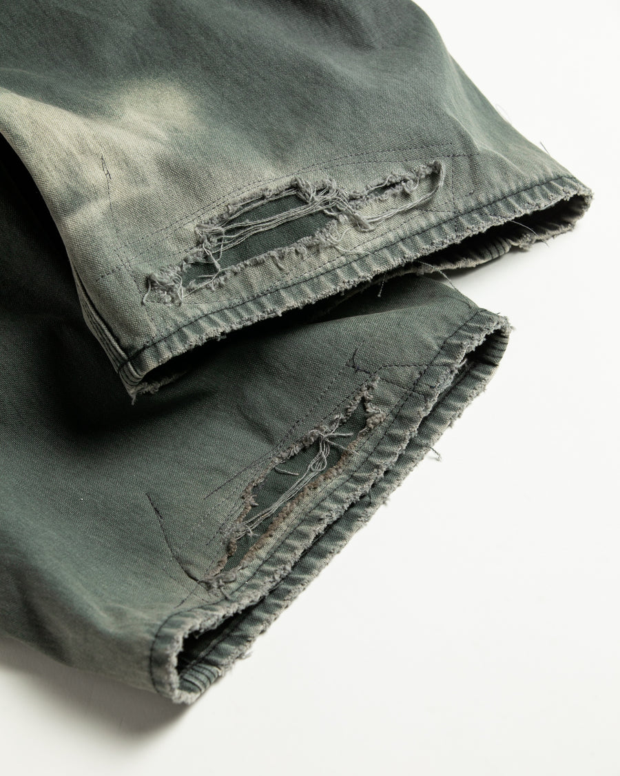 【 商品名：リメイクダブルニーダックペインターパンツ 】

本製品は、レングスをやや長めに設定したブラックカラーのペインターパンツです。ウエスト部分にはナイロンオックス生地で切り替えを施し、ワーク感を抑えつつバランスの良いデザインに仕上げています。生地には頒布の中でも最も薄手の11号帆布生地を使用しており、強度・耐久性に優れるだけでなく、着用を重ねるごとにアタリなどの経年変化を楽しめる素材です。また、水や薬品の使用量を抑えながら生地の凹凸部分のアタリを強調し、同時に自然な脱色感を与える特殊エイジング加工に加え、サンフェードによるダメージ加工も施すことで、より味わい深い表情に仕上げています。