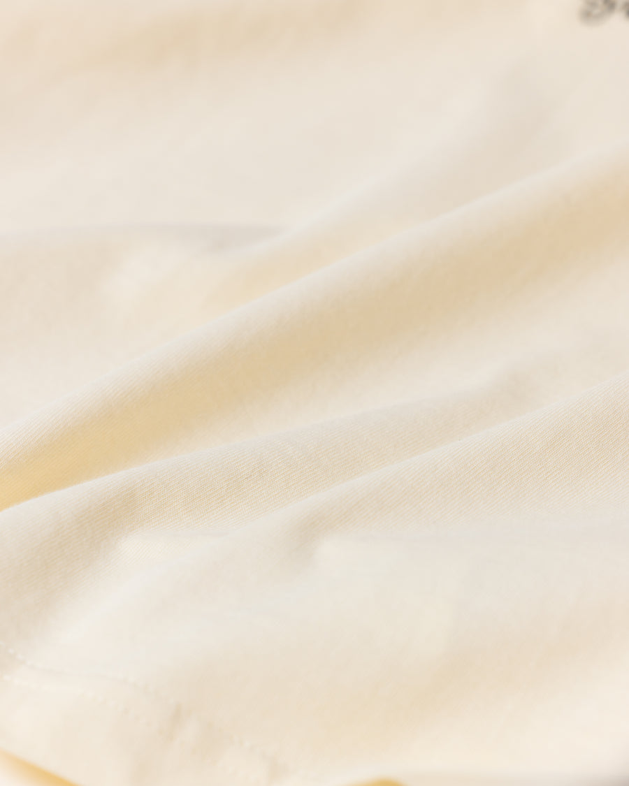 ANACHRONORM × Souvenyr NYC フェイシズ 半袖Tシャツ ベージュ | コラボグラフィック ニューヨーク コットン100%