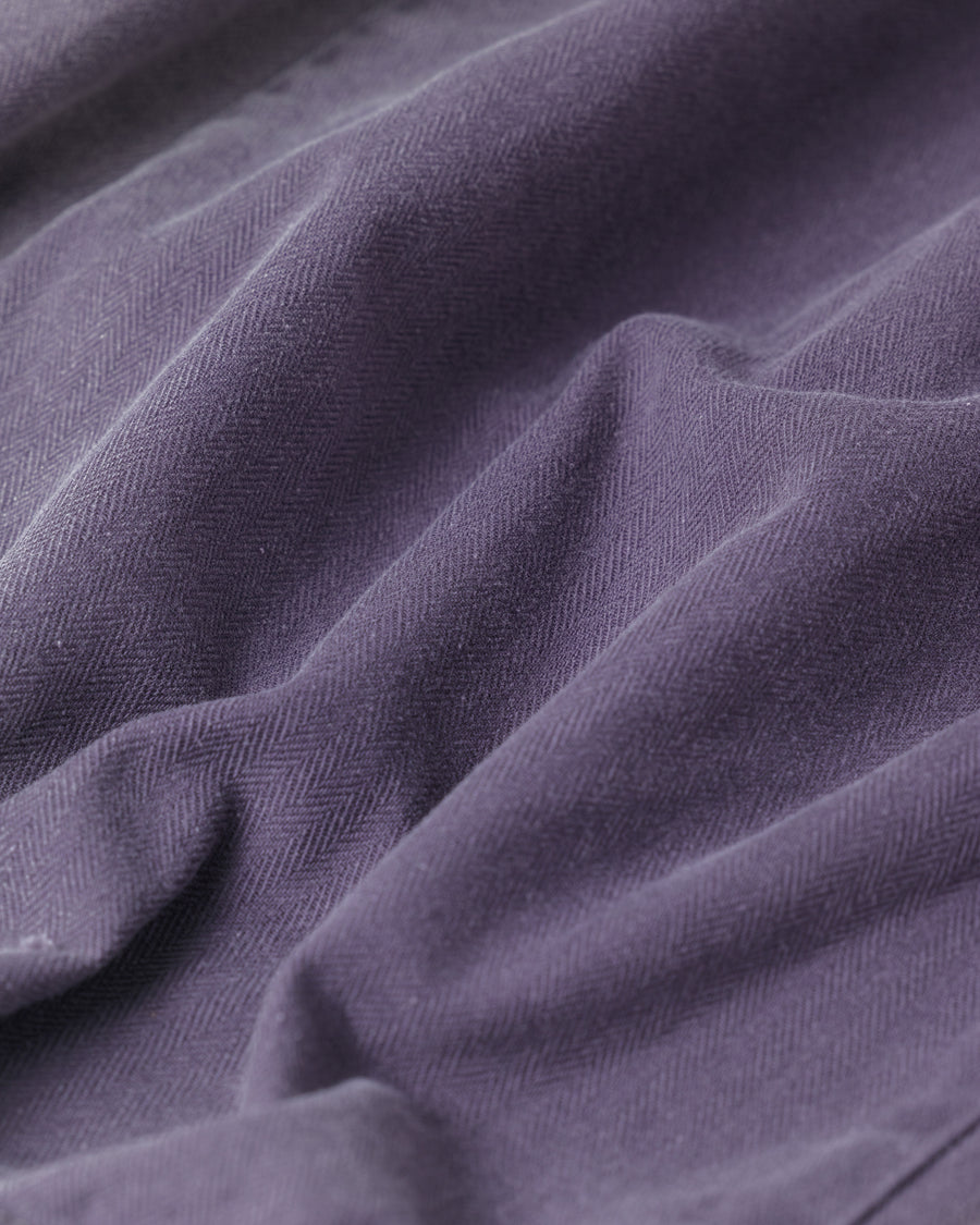 ミリタリーのシャツジャケットを現代的シルエットに更新。裾のドローコードでスタイルに合わせた変化を楽しめます。素材には肌馴染みの良い10sヘリンボンを採用。環境に配慮した特殊エイジング・サンフェード加工とダメージ加工を施すことで、クラシカルな生地にリアリティのある褪色感とヴィンテージライクな佇まいを表現しました。

A modern military shirt jacket with hem drawcords for an adjustable silhouette. Crafted from soft 10s herringbone, this CHARCOAL piece undergoes a special sun-fade and damage process. It achieves a realistic, time-worn vintage look with authentic distressing while minimizing environmental impact through eco-conscious processing.