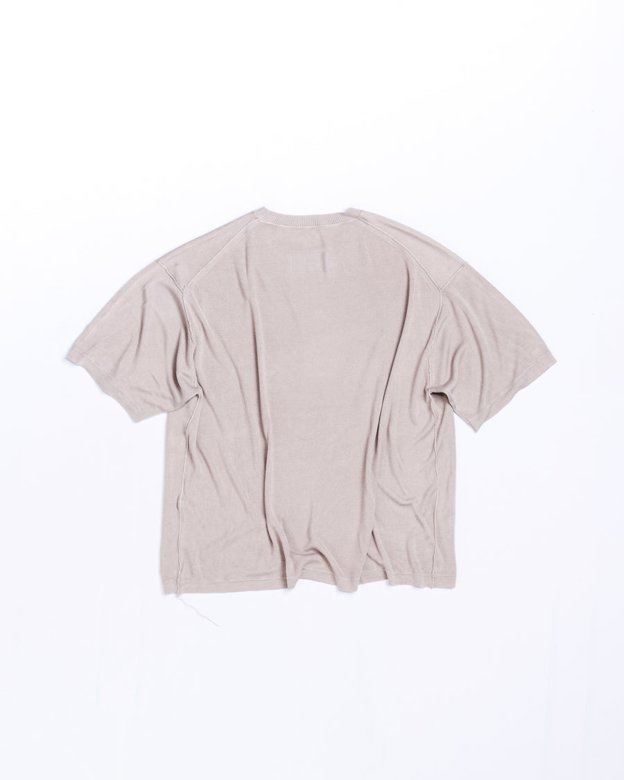 ディテールを極限まで削ぎ落とし、着心地とシルエットを追求したニットTシャツ。気候変化に対応する新たなアプローチとして、軽量で吸水・放湿性に優れた竹（バンブー）素材を採用しました。滑らかでとろみのある肌触りと、袖を通した瞬間に感じる清涼感は格別です。家庭洗濯も可能で、日常に圧倒的な心地よさを提供します。

A minimalist knit T-shirt focused entirely on fit and comfort. Crafted from bamboo yarn, this lightweight, durable material offers exceptional moisture absorption and a refreshing cool-to-the-touch feel. This LIGHT BEIGE piece features a silky, fluid drape that provides overwhelming comfort, perfect for changing climates, and is conveniently home-washable.