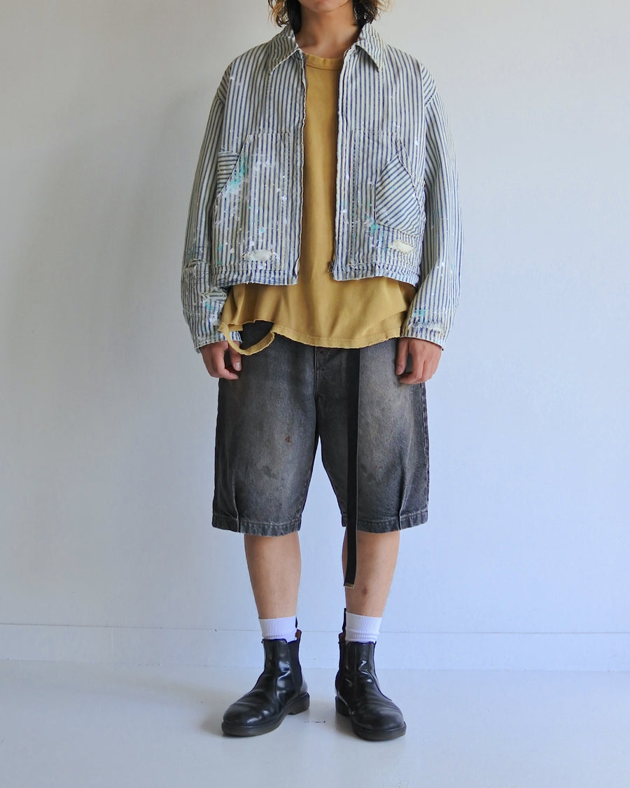 ゆとりある身幅とややクロップド丈でレイヤードを楽しめるデザインにしたヒッコリージャケット。
岡山県製9ozヒッコリーストライプ生地を使用し、ハリのあるしっかりとした風合いが特徴。
全体にエイジングとハードダメージを施し、手作業のステッチ補修とランダムなペンキでリアルな表情に仕上げています。