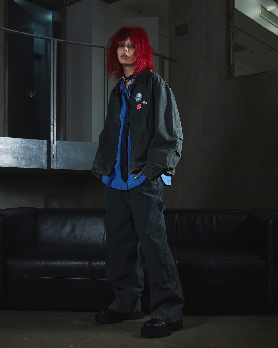 【 商品名：ダブルニーダックペインターパンツ 】

本製品は、レングスをやや長めに設定したブラックカラーのペインターパンツです。ウエスト部分にはナイロンオックス生地で切り替えを施し、ワーク感を抑えた上品なデザインに仕上げています。生地には頒布の中でも最も薄手の11号帆布生地を採用しており、強度・耐久性に優れるとともに、着用を重ねるごとにアタリなどの経年変化を楽しめる素材です。また、水や薬品の使用量を抑えながら生地の凹凸部分のアタリを強調し、同時に自然な脱色感を加える特殊エイジング加工を施しています。